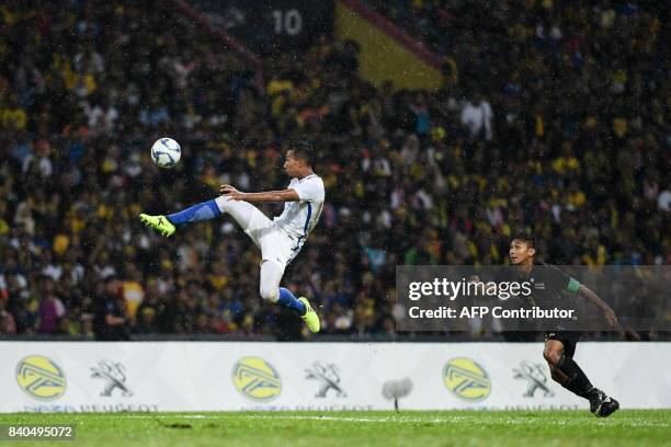 Thailand's Chenrop Samphaodi watches as Malaysia's Adam Nor Azlin controls the ball during the men's football final between Thailand and Malaysia at...