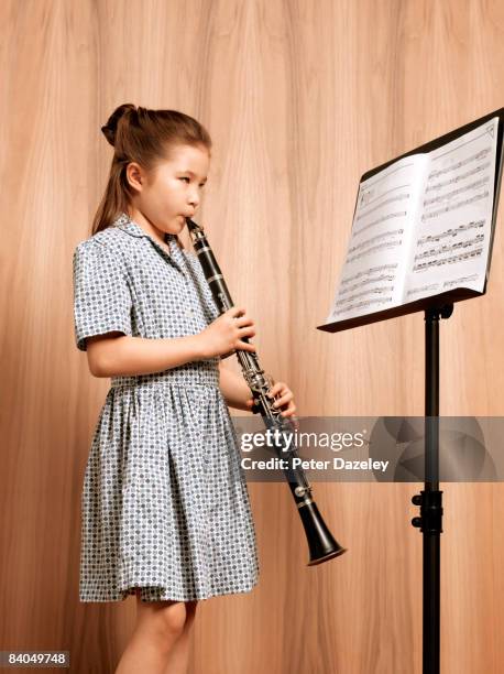 young girl playing clarinet - クラリネット ストックフォトと画像