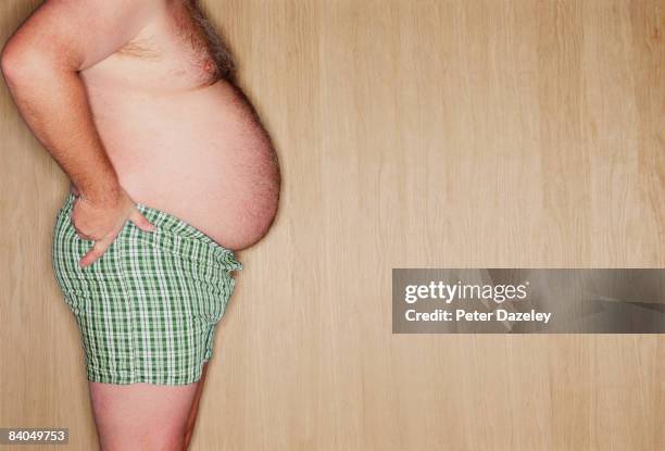 profile of obese man - pot belly fotografías e imágenes de stock