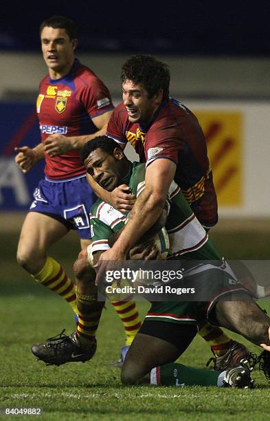 Seru Rabeni of Leicester is tackled by Nathan Hines of Perpignan during the Heineken Cup match between Perpignan and Leicester Tigers at Stade Aime...