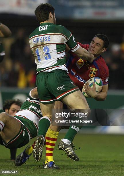 Dan Carter of Perpignan is tackled by Danny Hipkiss of Leicester Tigers during the Heineken Cup match between Perpignan and Leicester Tigers at Stade...