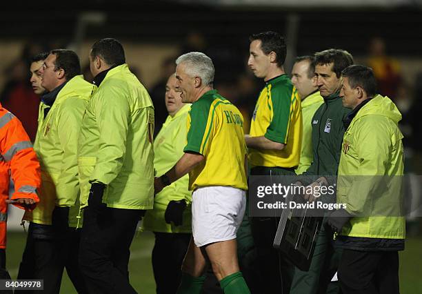 Referee Allan Lewis is escorted off the field during the Heineken Cup match between Perpignan and Leicester Tigers at Stade Aime Giral on December...