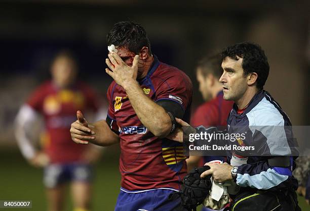 Ovidiu Tonita of Perpignan is helped off the field with a cut head during the Heineken Cup match between Perpignan and Leicester Tigers at Stade Aime...