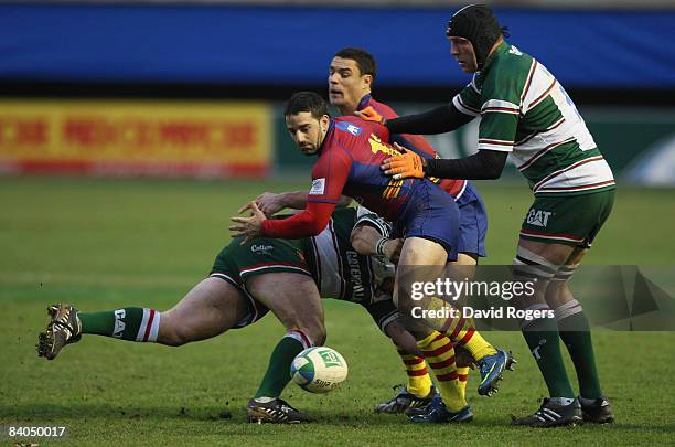 Julien Candelon of Perpignan loses the ball after being tackled during the Heineken Cup match between Perpignan and Leicester Tigers at Stade Aime...