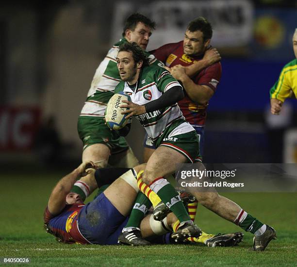 Julien Dupuy of Leicester runs with the ball during the Heineken Cup match between Perpignan and Leicester Tigers at Stade Aime Giral on December 14,...