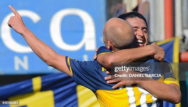 Forward Luciano Figueroa and midfielder Juan Roman Riquelme of Boca Juniors celebrate the third goal of their team against Colon during their...