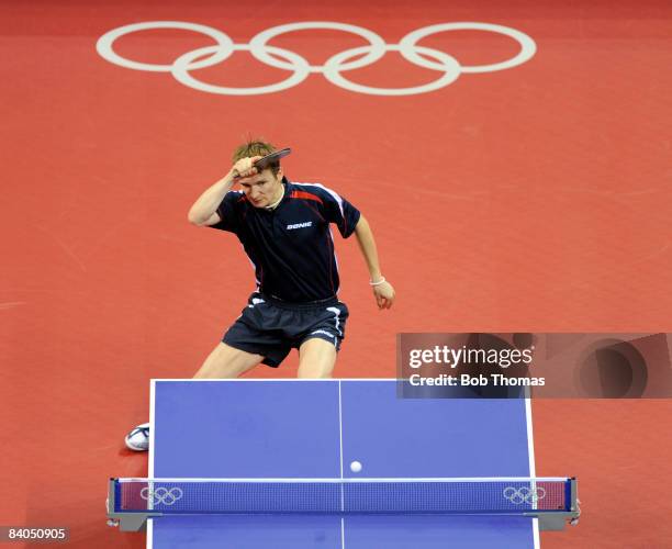 Werner Schlager of Austria plays against Andrej Gacina of Croatia during their Men's Team Bronze Play-off Round 1 match at the Peking University...