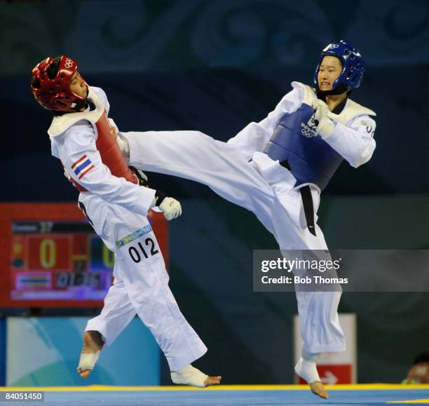 Jingyu Wu of China against Buttree Puedpong of Thailand during the Women's Gold Medal taekwondo -49kg at the University of Science and Technology...