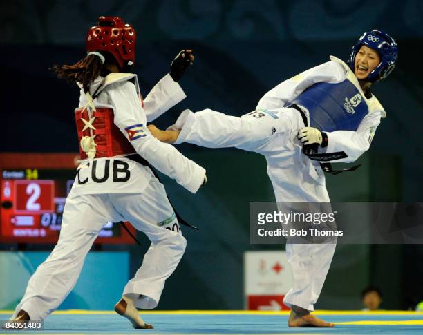 Shu-Chun Yang of Taipei against Daynellis Montejo of Cuba during the Women's taekwondo Bronze medal match-49kg at the University of Science and...