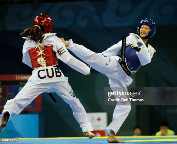 Shu-Chun Yang of Taipei against Daynellis Montejo of Cuba during the Women's taekwondo Bronze medal match-49kg at the University of Science and...