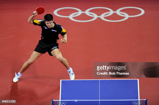 Dimitrij Ovtcharov of Germany plays against Adrian Crisan of Romania during their men's table tennis single preliminary match during Day 12 of the...