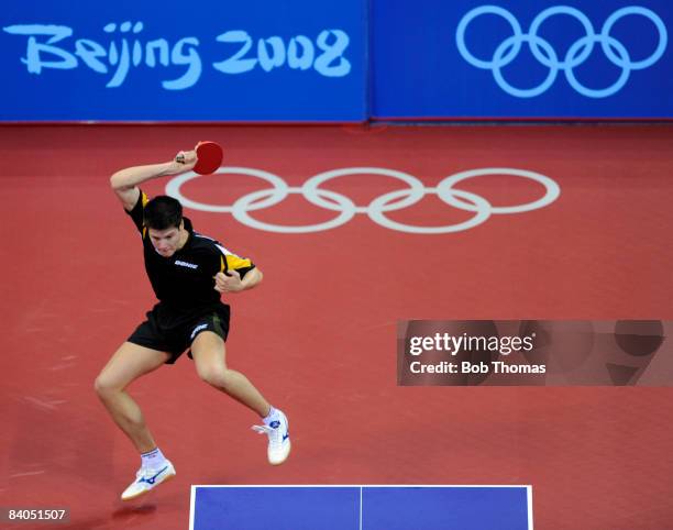 Dimitrij Ovtcharov of Germany plays against Adrian Crisan of Romania during their men's table tennis single preliminary match during Day 12 of the...