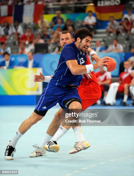 Nikola Karabatic of France with Sverre Andreas Jakobsson of Iceland during the Men's Handball Gold Medal Match between France and Iceland held at the...