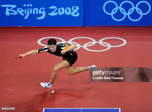 Dimitrij Ovtcharov of Germany plays against Adrian Crisan of Romania during their men's table tennis single preliminary match during Day 12 of the...