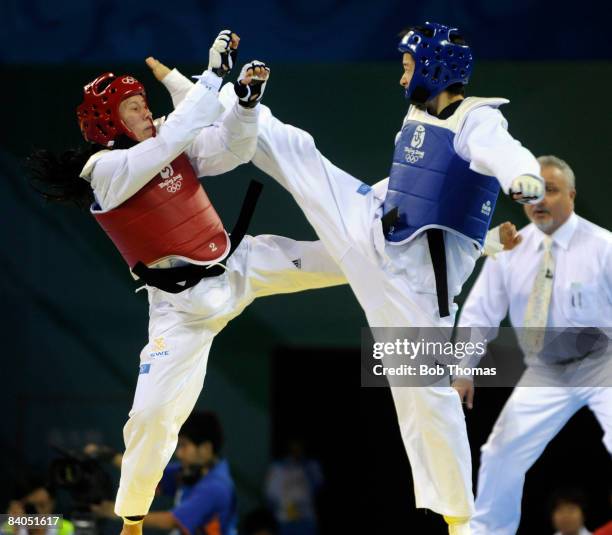 Jingyu Wu of China against Hanna Zajc of Sweden during the Women's taekwondo -49kg at the University of Science and Technology Gymnasium during Day...