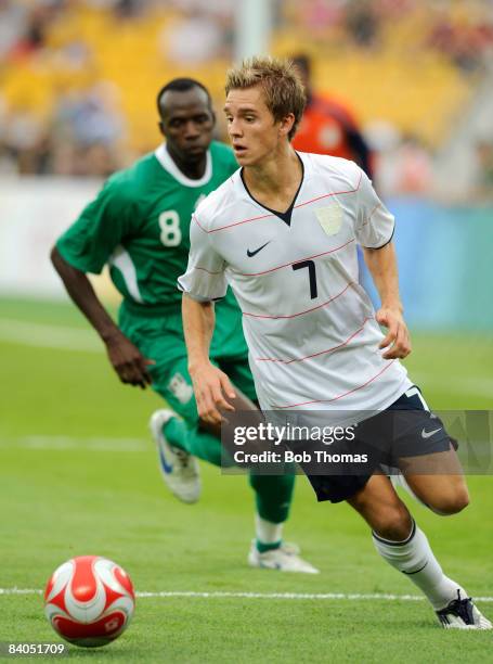 Stuart Holden of the United States with Sani Kaita of Nigeria during the Men's First Round Group B match between Nigeria and the United States at the...