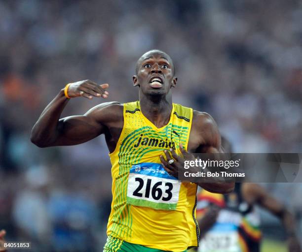 Usain Bolt of Jamaica celebrates after breaking the world record with a time of 19.30 seconds to win the gold medal in the Men's 200m Final at the...