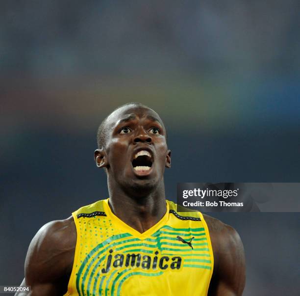 Usain Bolt of Jamaica celebrates after breaking the world record with a time of 19.30 seconds to win the gold medal in the Men's 200m Final at the...