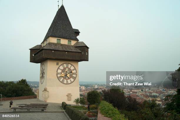 graz clock tower on schlossberg or castle hill, graz, styria, austria, europe - turmuhr stock-fotos und bilder