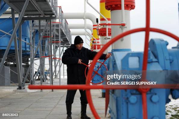 A Naftogaz gas company worker adjusts va A Naftogaz gas company worker adjusts va