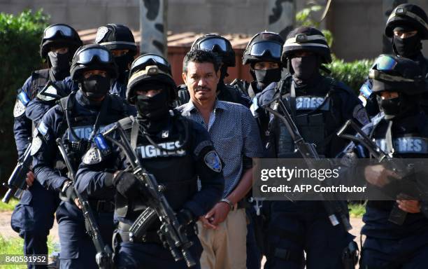 Honduran alleged drug trafficker Arnulfo Fagot Maximo, aka "El Tio," wanted in the United States, is escorted by members of the elite police unit...