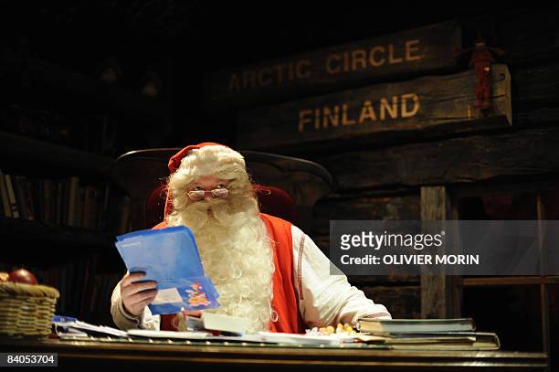 Santa Claus reads letters coming in from the world in his "office" in Rovaniemi, on December 16, 2008. Rovaniemi's Christmas theme park is in full...