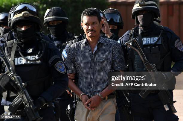 Honduran alleged drug trafficker Arnulfo Fagot Maximo, aka "El Tio," wanted in the United States, is escorted by members of the elite police unit...