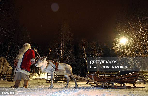 Santa Claus stands with his Reindeer near his "office" in Rovaniemi, on December 16, 2008. Rovaniemi's Christmas theme park is in full swing, teeming...