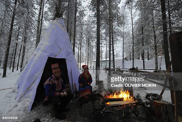 Couple in traditional Laplander costume are pictured in Rovaniemi, on December 16, 2008. Rovaniemi's Christmas season is in full swing, teeming...