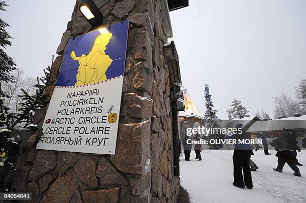 Tourists walk in a Christmas park at the border of the Arctic Circle in Rovaniemi, on December 16, 2008. Rovaniemi's Christmas season is in full...