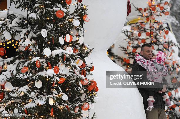 Man and his daughter looks at the Christmas trees decorated in a Christmas park in Rovaniemi, on December 16, 2008. Rovaniemi's Christmas season is...