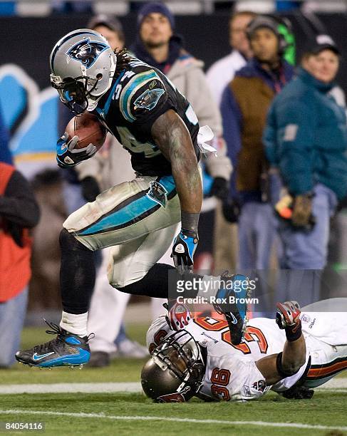 DeAngelo Williams of the Carolina Panthers works to get by Tanard Jackson of the Tampa Bay Buccaneers during the second half on December 8, 2008 at...