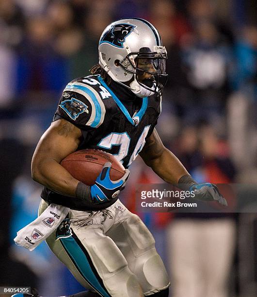 DeAngelo Williams of the Carolina Panthers carries for a first down against the Tampa Bay Buccaneers on December 8, 2008 at Bank of America Stadium...