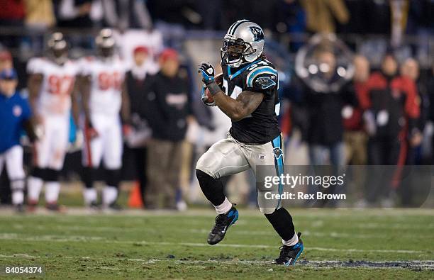 DeAngelo Williams of the Carolina Panthers carries for a first down against the Tampa Bay Buccaneers on December 8, 2008 at Bank of America Stadium...