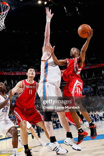 Rafer Alston of the Houston Rockets goes up against Robert Swift of the Oklahoma City Thunder on November 17, 2008 at the Ford Center in Oklahoma...