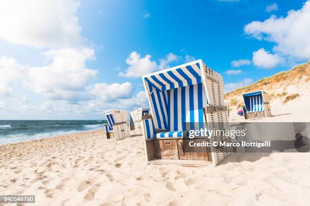 strandkorb beach baskets. sylt island, germany. - beach shelter stock-fotos und bilder