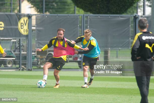 Mario Goetze of Dortmund and Felix Passlack of Dortmund battle for the ball during a training session at the BVB Training center on July 16, 2017 in...