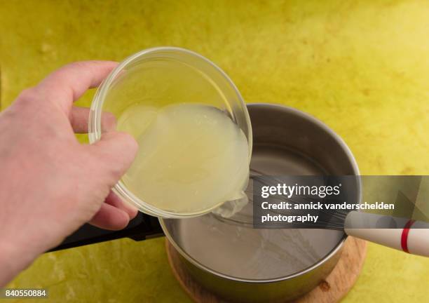 adding lime juice in mixture agar with water for gelation purposes. - agar jelly stock pictures, royalty-free photos & images