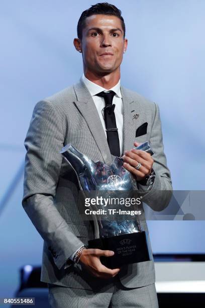 Cristiano Ronaldo of Real Madrid poses with his trophy of Best Men's player in Europe during the UEFA Champions League Group stage draw ceremony, at...