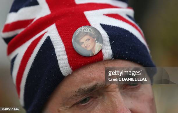 Royal fans John Loughrey wears a Union flag themed hat adorned with a picture of Britain's Diana, Princess of Wales, as he talks to media outside one...