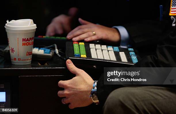 The hands of financial professionals use a keyboard on the floor of the New York Stock Exchange during afternoon trading December 16, 2008 in New...