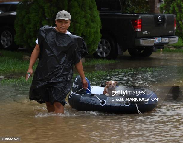 John Tuan returns to rescue his dog who was left in his flooded house in the Clodine district after Hurricane Harvey caused heavy flooding in...