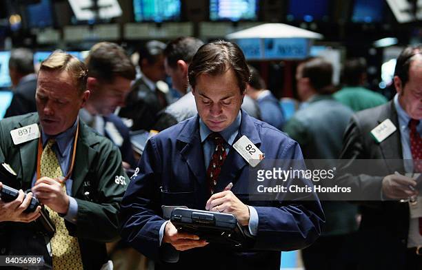 Financial professional works with a hand-held computer on the floor of the New York Stock Exchange at the end of the trading day December 16, 2008 in...