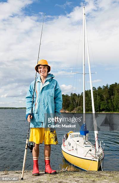 guy next to boat - young men fishing stock pictures, royalty-free photos & images