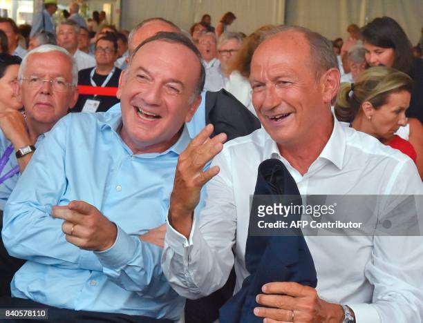 Oreal CEO Jean-Paul Agon talks with Medef head Pierre Gattaz at the French employers association Medef summer University meeting in Jouy-en-Josas on...