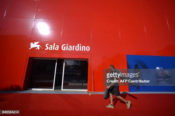 Man works near the entrance of a screening room on the eve of the 74th Venice Film Festival on August 29, 2017 at Venice Lido. The 74th Venice film...