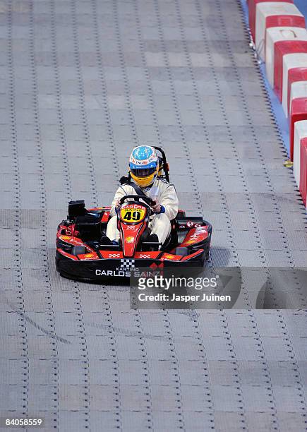 Formula one driver Fernando Alonso steers a kart during the 'Iker Vs Rafa' charity game at the Palacio de Deportes de la Comunidad de Madrid on...