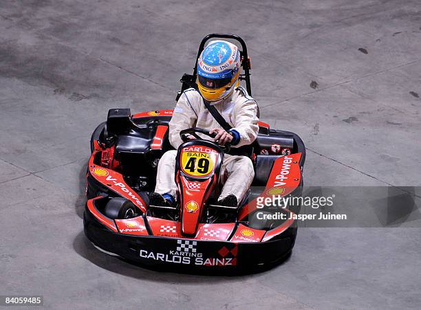 Formula one driver Fernando Alonso steers his kart during the 'Iker Vs Rafa' charity game at the Palacio de Deportes de la Comunidad de Madrid on...