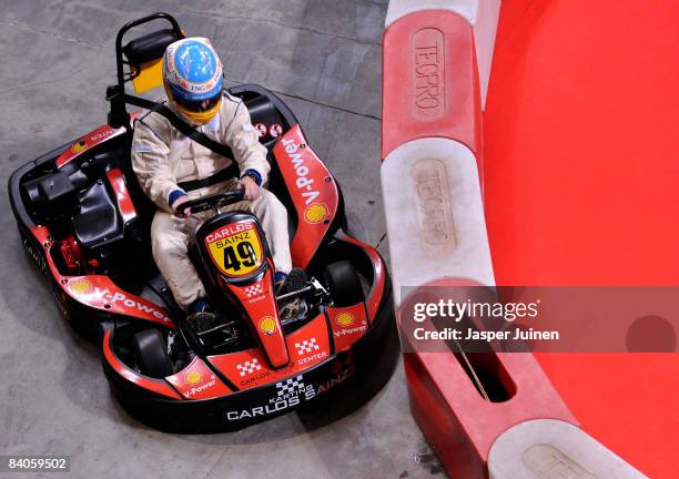 Formula one driver Fernando Alonso steers his kart through a curve during the 'Iker Vs Rafa' charity game at the Palacio de Deportes de la Comunidad...