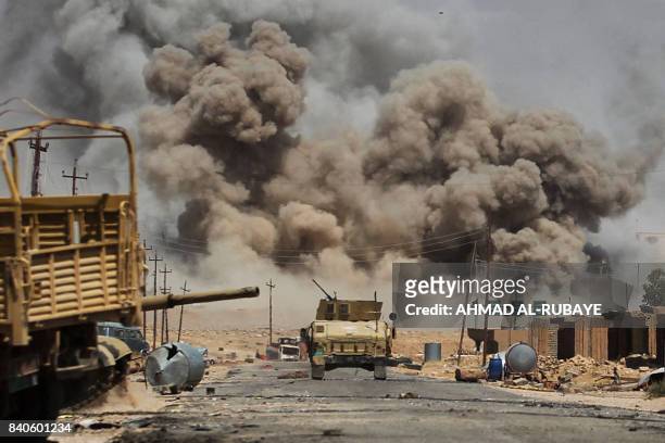 Smoke billows as Iraqi forces advance towards Al-Ayadieh village, the last remaining active front line near Tal Afar, during an operation to retake...